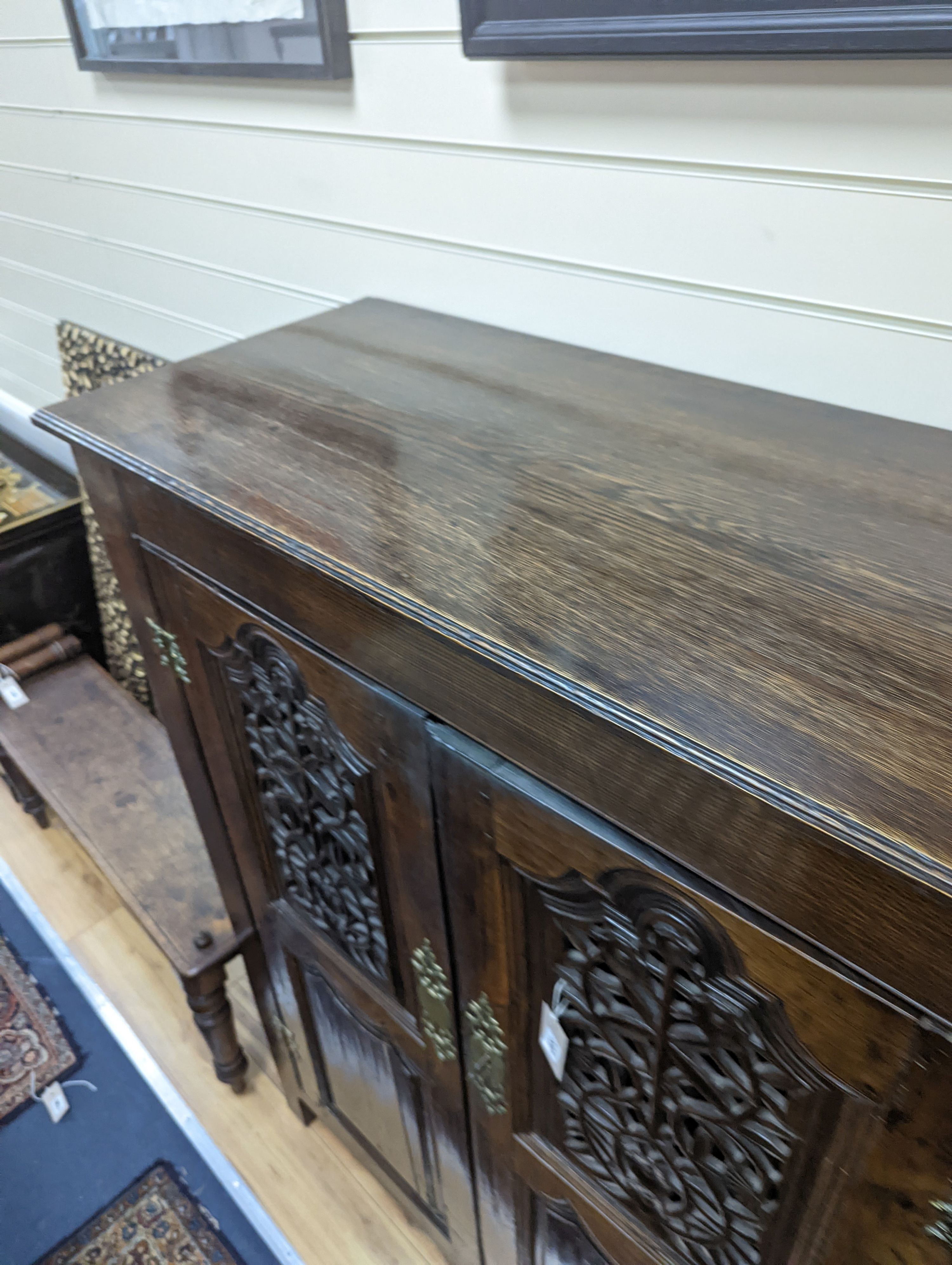 An 18th century and later French carved oak side cabinet. W-112cm, D-46cm, H-136cm.